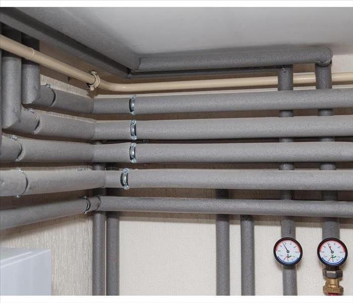 Isolation ducts and pressure gauges flow and return pipes in the boiler room of a private house