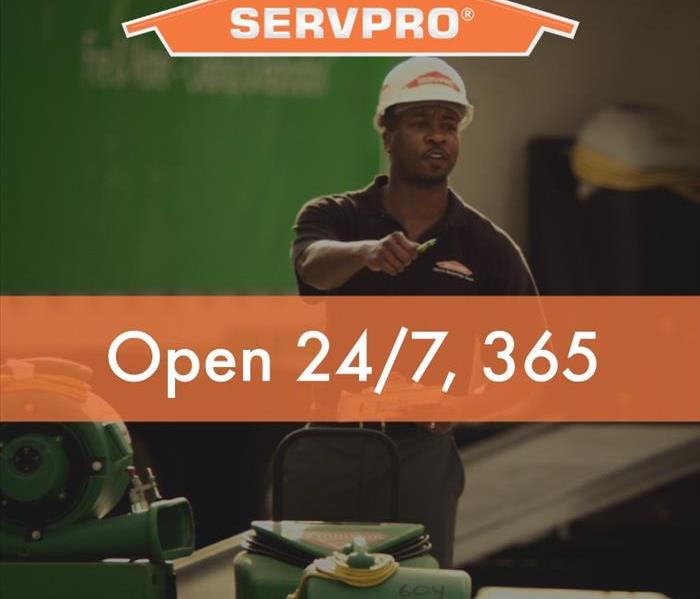 Background of a SERVPRO worker wearing helmet, Servpro Logo, 24/7/365