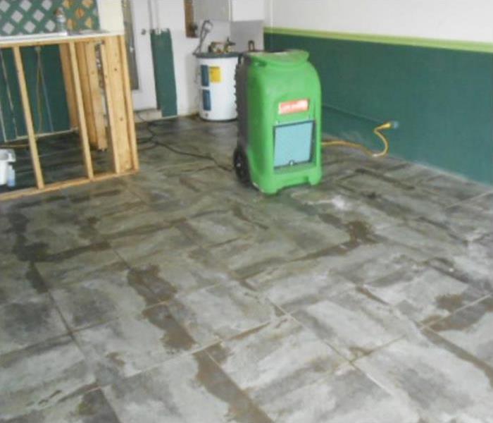 dehumidifier placed on a room, floor is being dried up.